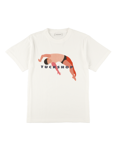 White cotton t-shirt featuring a colorful graphic print and the word 'TUCKSHOP' on the front.