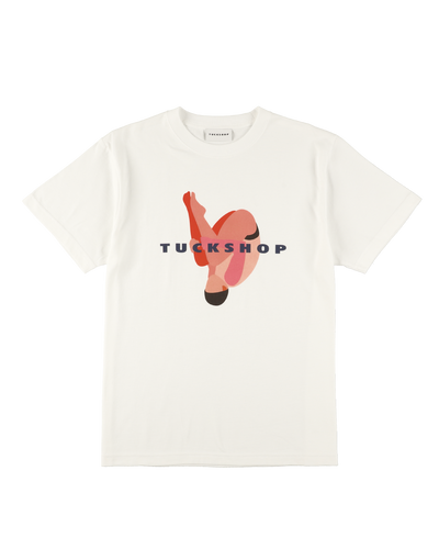 White T-shirt featuring a colorful graphic design with the text 'TUCKSHOP' on the front.