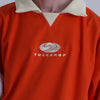 FOOTBALL POLO PULLOVER、オレンジ色の襟付きプルオーバーでTUCKSHOPロゴが胸に刺繍されている