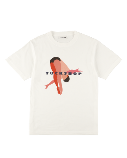 White cotton t-shirt with a graphic print featuring a minimalist figure and the word 'TUCKSHOP'.