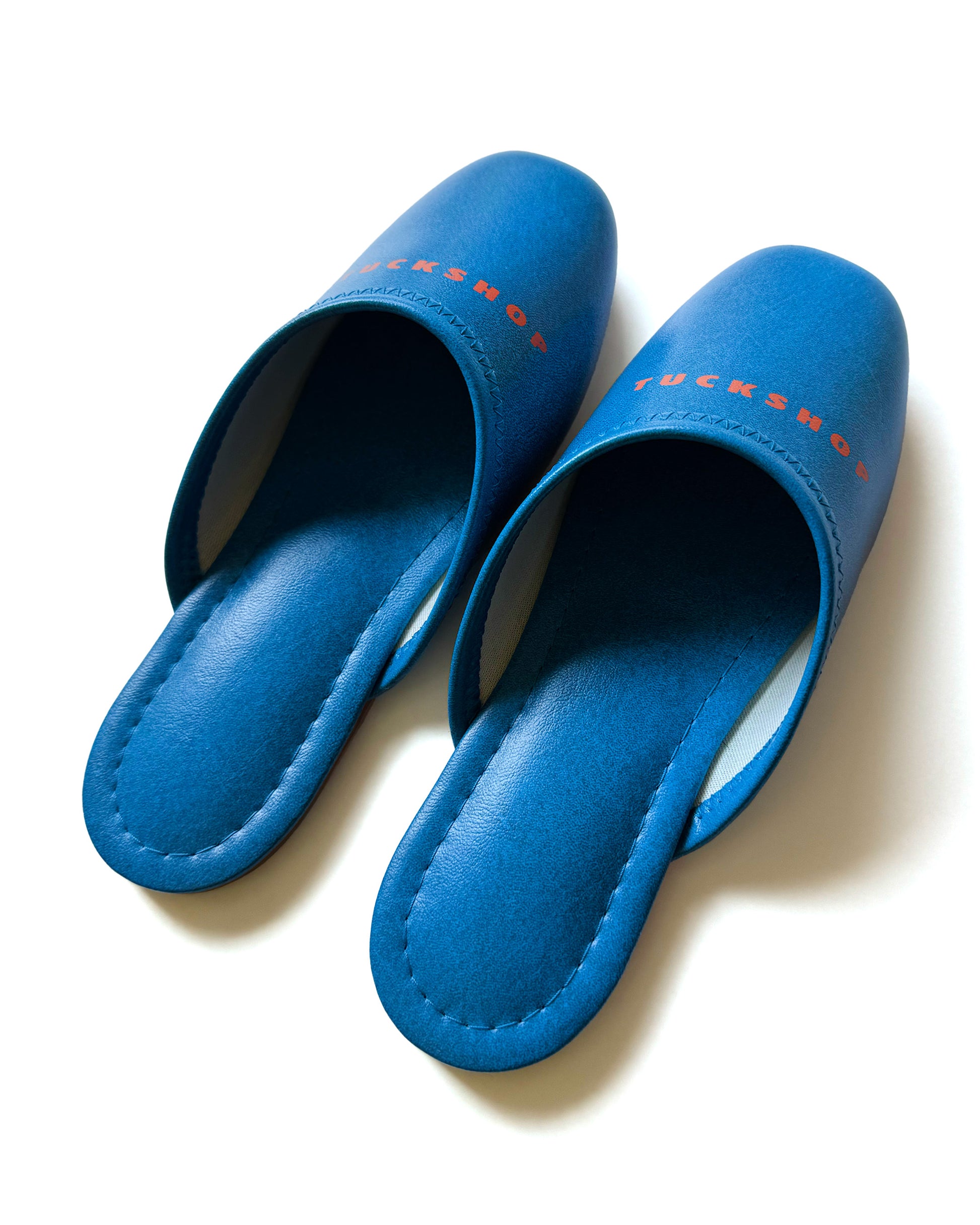 Blue faux leather indoor slippers with logo print, featuring a comfortable design and a sleek finish.