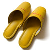 Yellow faux leather slippers with logo print, indoor use, comfortable design, stylish and modern footwear.