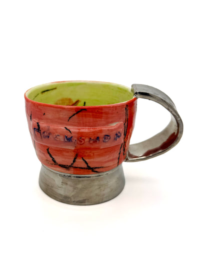 Handcrafted PLATINUM MUG featuring vibrant red and green colors with embossed logo and platinum coating.